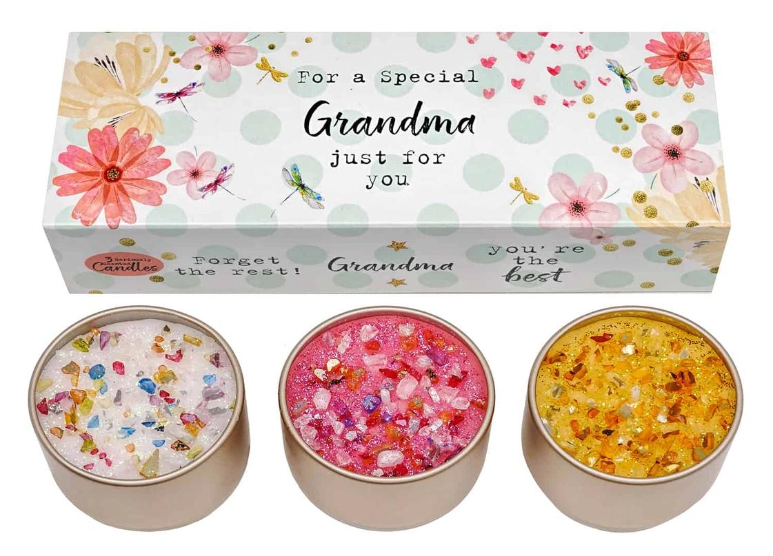 A set of three multicolored candles in tin containers with floral patterns on the labels, specifically designed for gifting with a 'Just for you' message and a box labeled 'For a Special Grandma'.