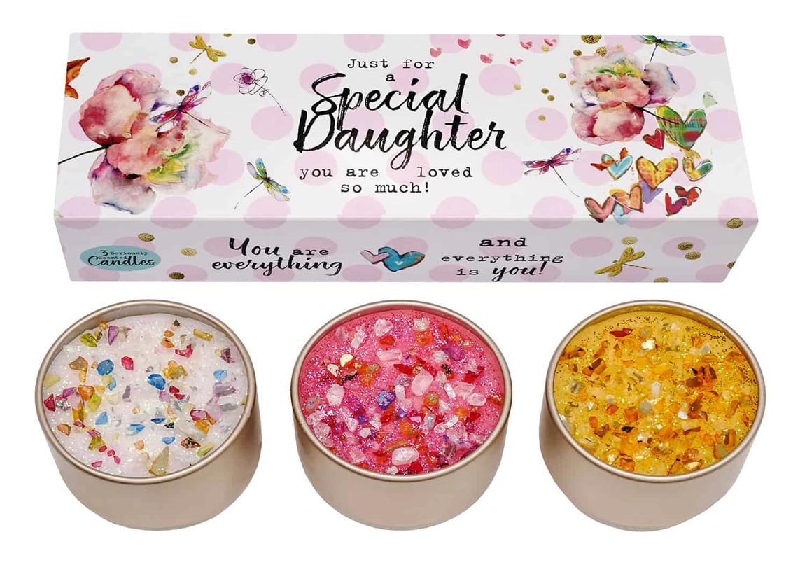 A set of three different colored candles in tin containers, each with a floral and butterfly design on the packaging, labeled as 'Special Daughter' by Best Kept Secrets.