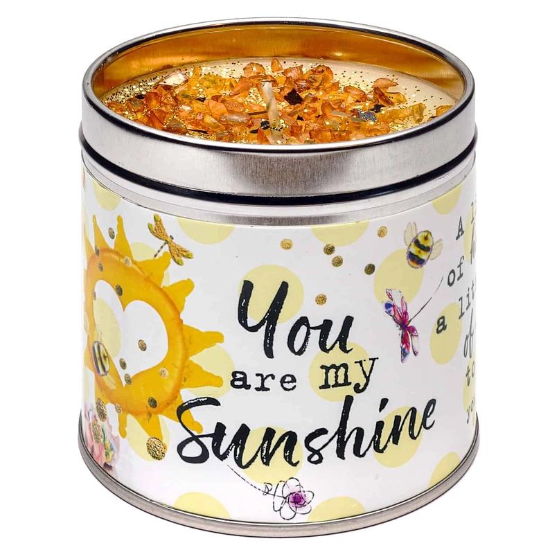 A tin candle with a 'You Are My Sunshine' message and decorated with sun and bee graphics.