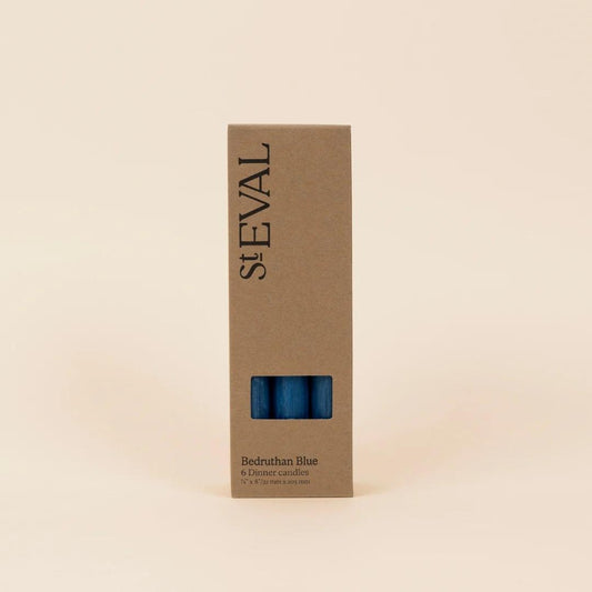 St. Eval candle box with blue candle inside on a beige background