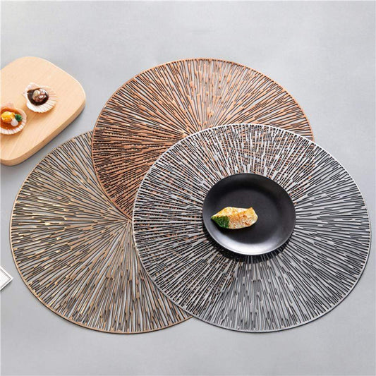 Three round placemats with textured patterns on a gray surface.