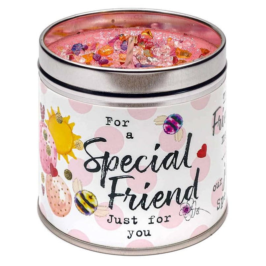 A tin candle with a pink label reading 'For a Special Friend' with decorative elements like stars and the text 'Just for you'.