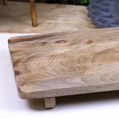 Wooden cutting board on a white surface with blurred background