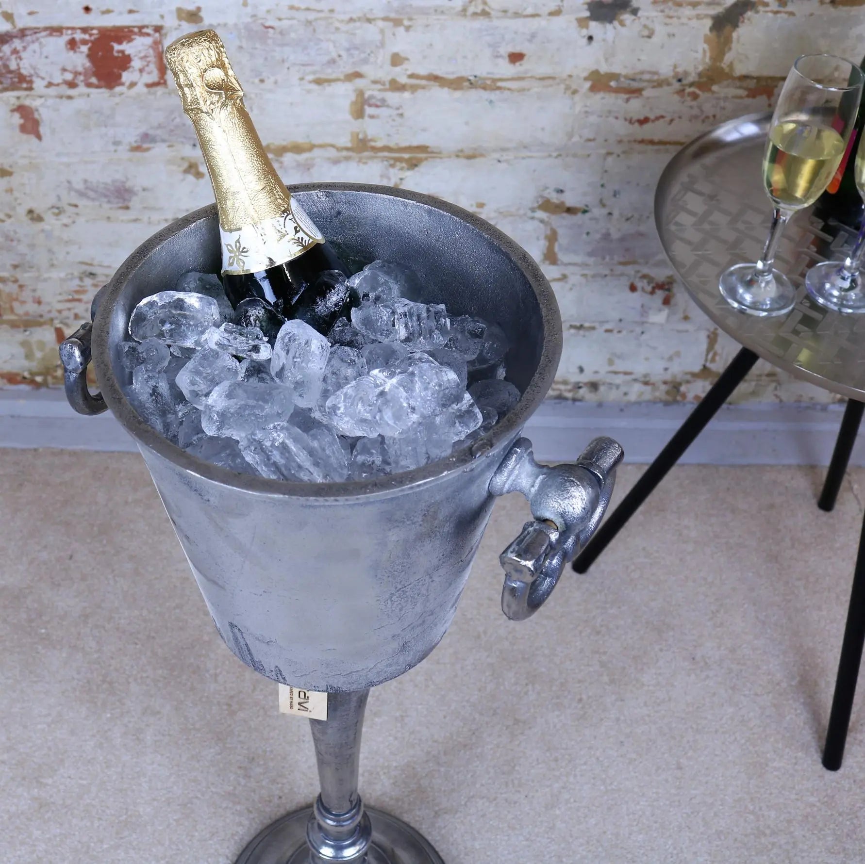Bottle of champagne in an ice bucket with a rustic background
