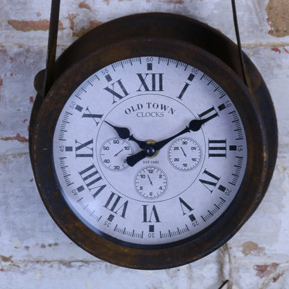 Vintage-style clock with Roman numerals on a textured wall background