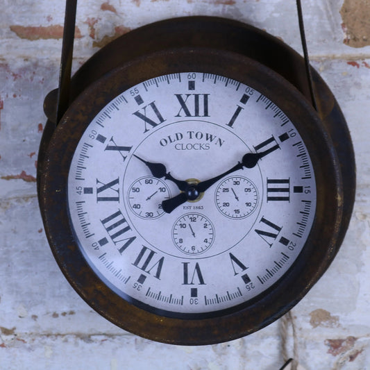 Vintage-style clock with Roman numerals on a textured wall background
