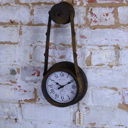 Vintage-style clock with pulley system on a textured brick wall
