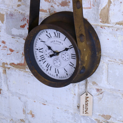 Vintage-style clock with Roman numerals on a textured wall