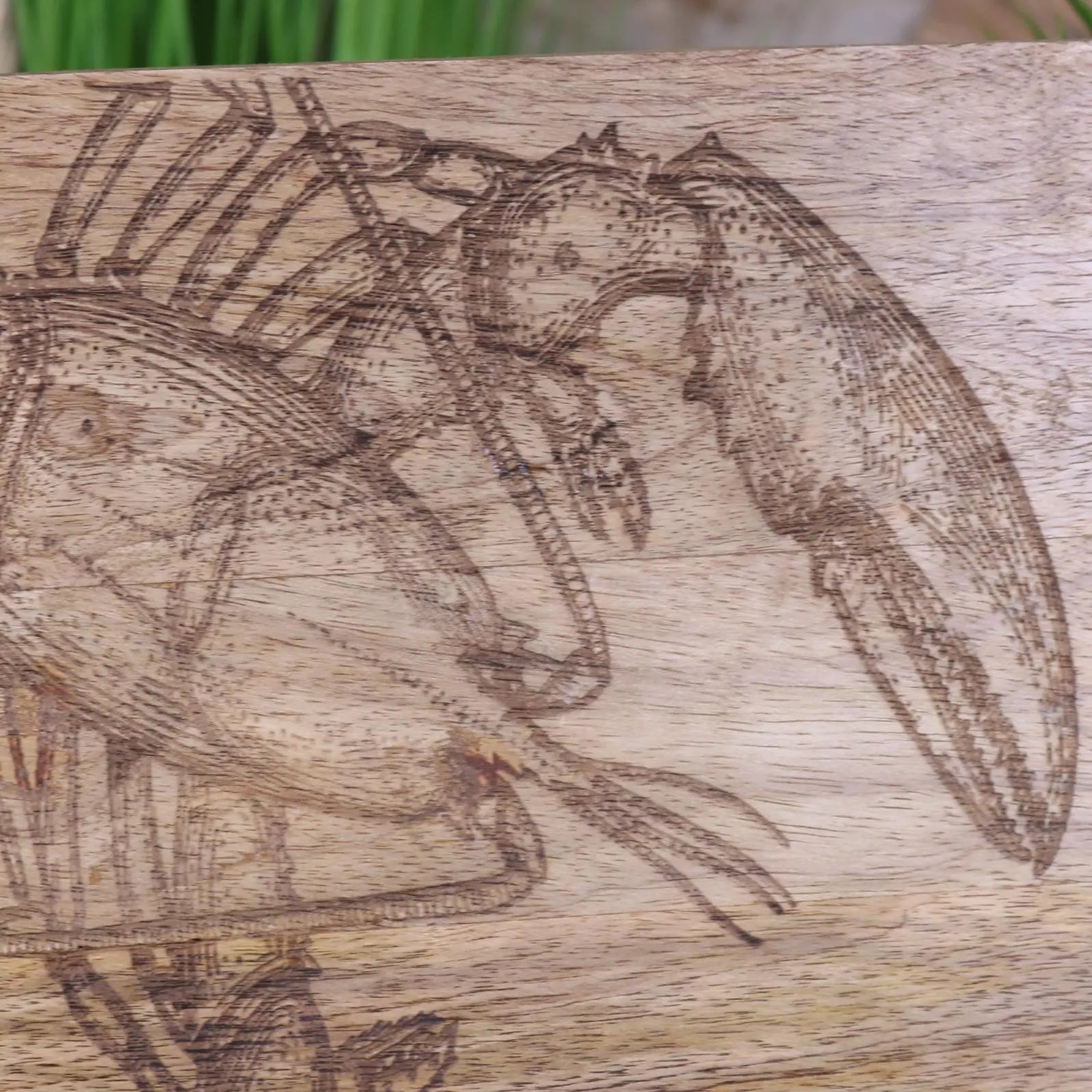 Wooden block with engraved design of a lobster