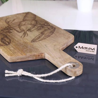 Wooden cutting board with lobster design on a dark surface, featuring a Matavi tag.