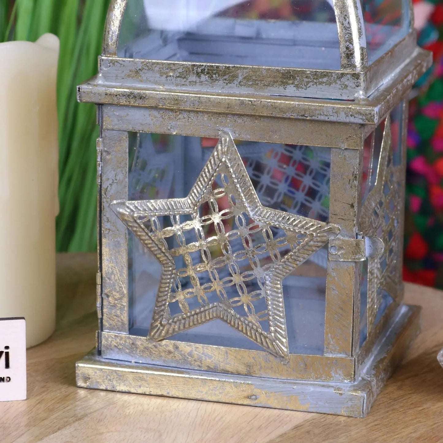 Decorative lantern with star design on a wooden surface