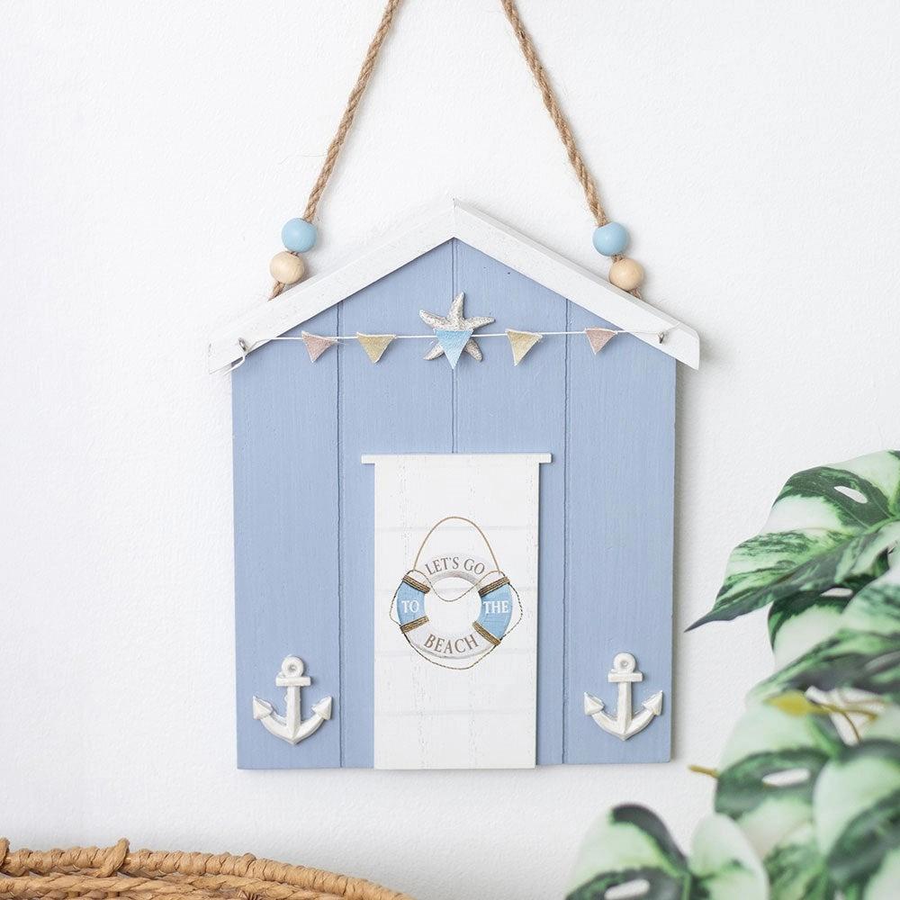 Decorative beach hut wall hanging with anchors and a life buoy design on a white background.