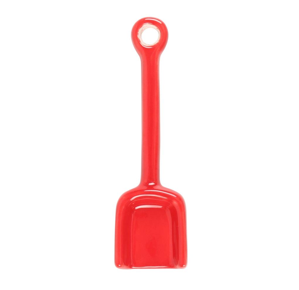 Red plastic shovel on a white background