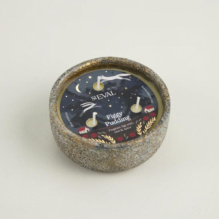 Candle with decorative label on a light gray background