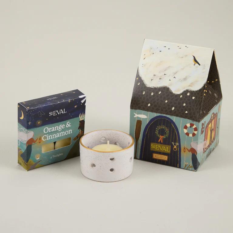 ST EVAL candle and packaging on a light gray background