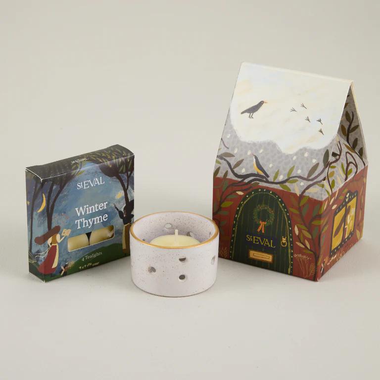ST Eval Winter Thyme candle with packaging on a light gray background