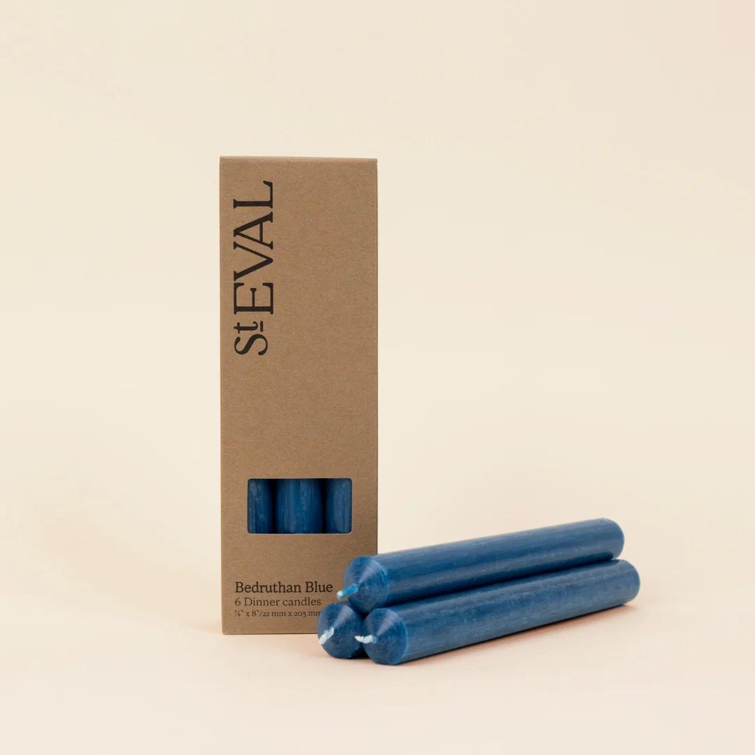 Blue candles with a St Eval cardboard box on a beige background