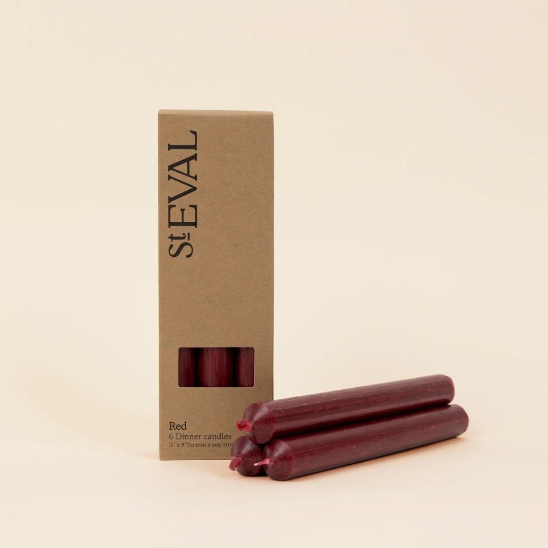 Red dinner candles with St Eval packaging on a beige background