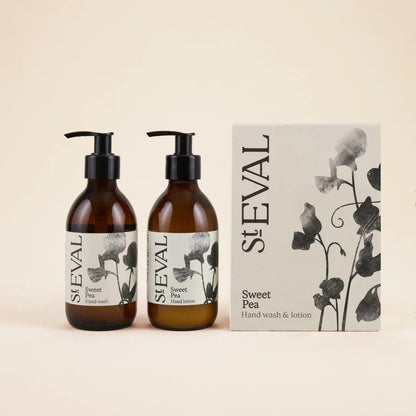 Two bottles of St. Eval Sweet Pea hand wash and lotion with a box on a beige background