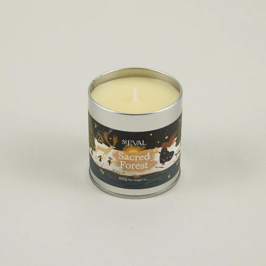 Candle in a metal tin labelled 'Sacred Forest' by ST Eval on a light grey background