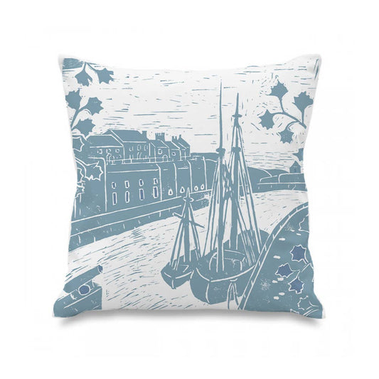 Decorative pillow with blue and white ship and building design on a white background