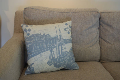 Decorative pillow with a ship design on a beige sofa