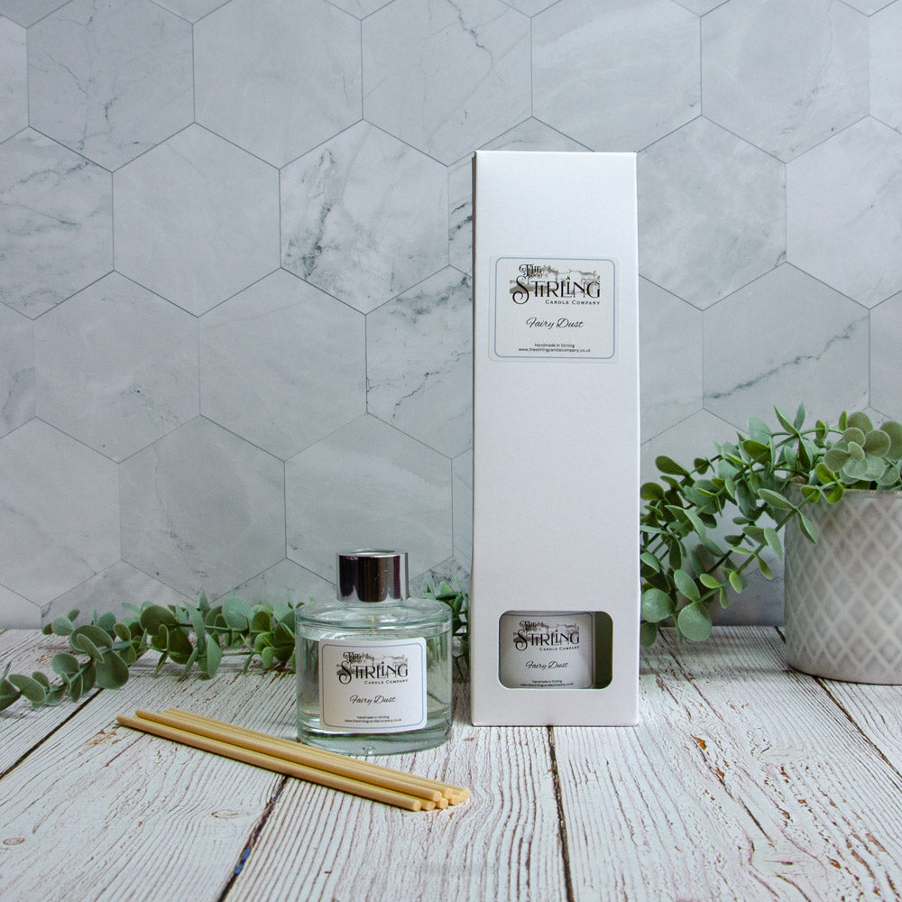 Diffuser and packaging on a wooden surface with a marble wall background