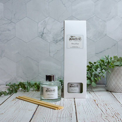 Diffuser and packaging on a wooden surface with a marble wall background